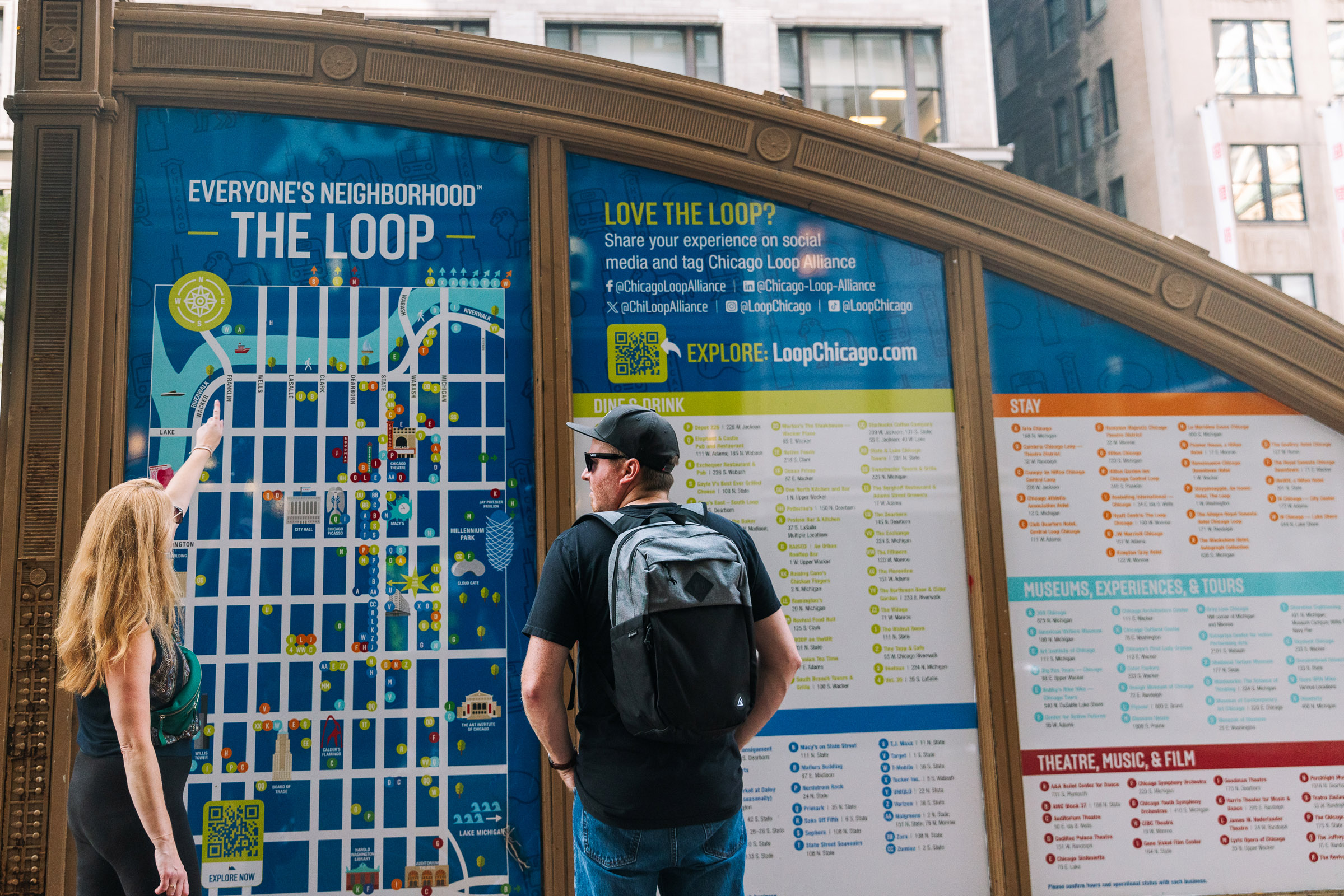 Man looking at a Chicago Loop Alliance Marketing Kiosk; photo by Faith Decker