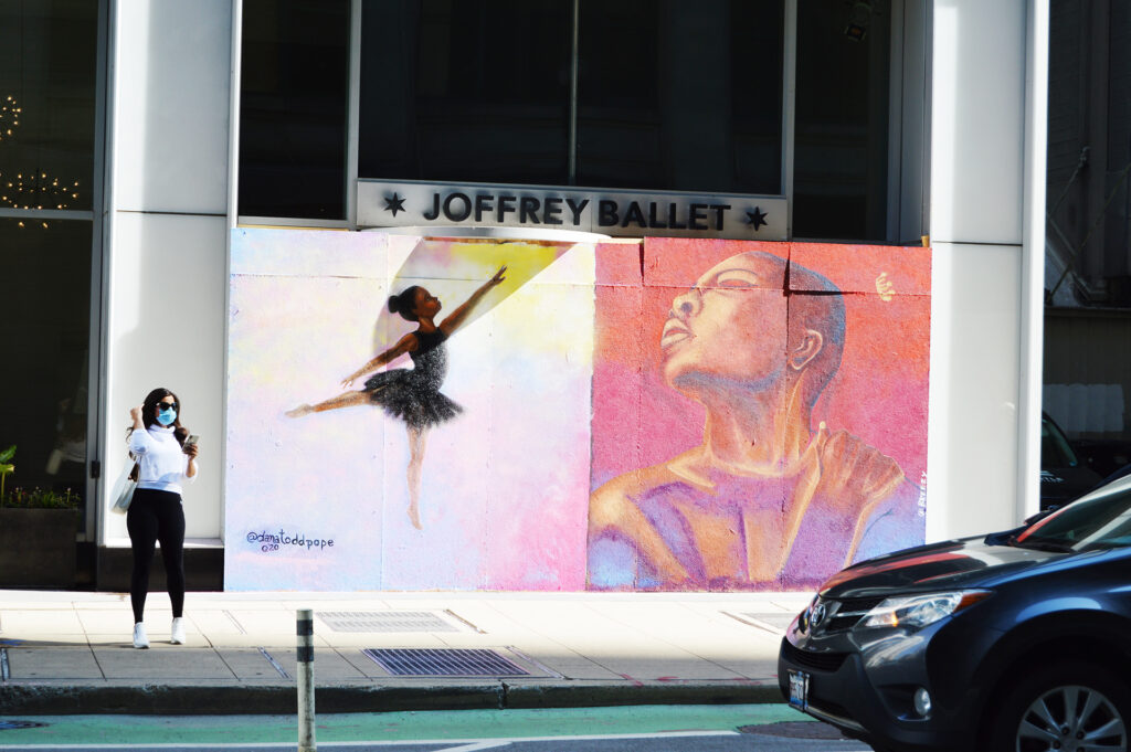 Artists transform boarded up storefronts with hopeful murals